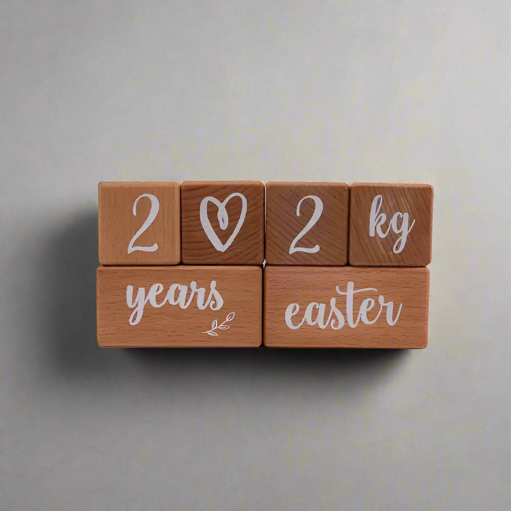 baby name milestone blocks displayed in nursery setting