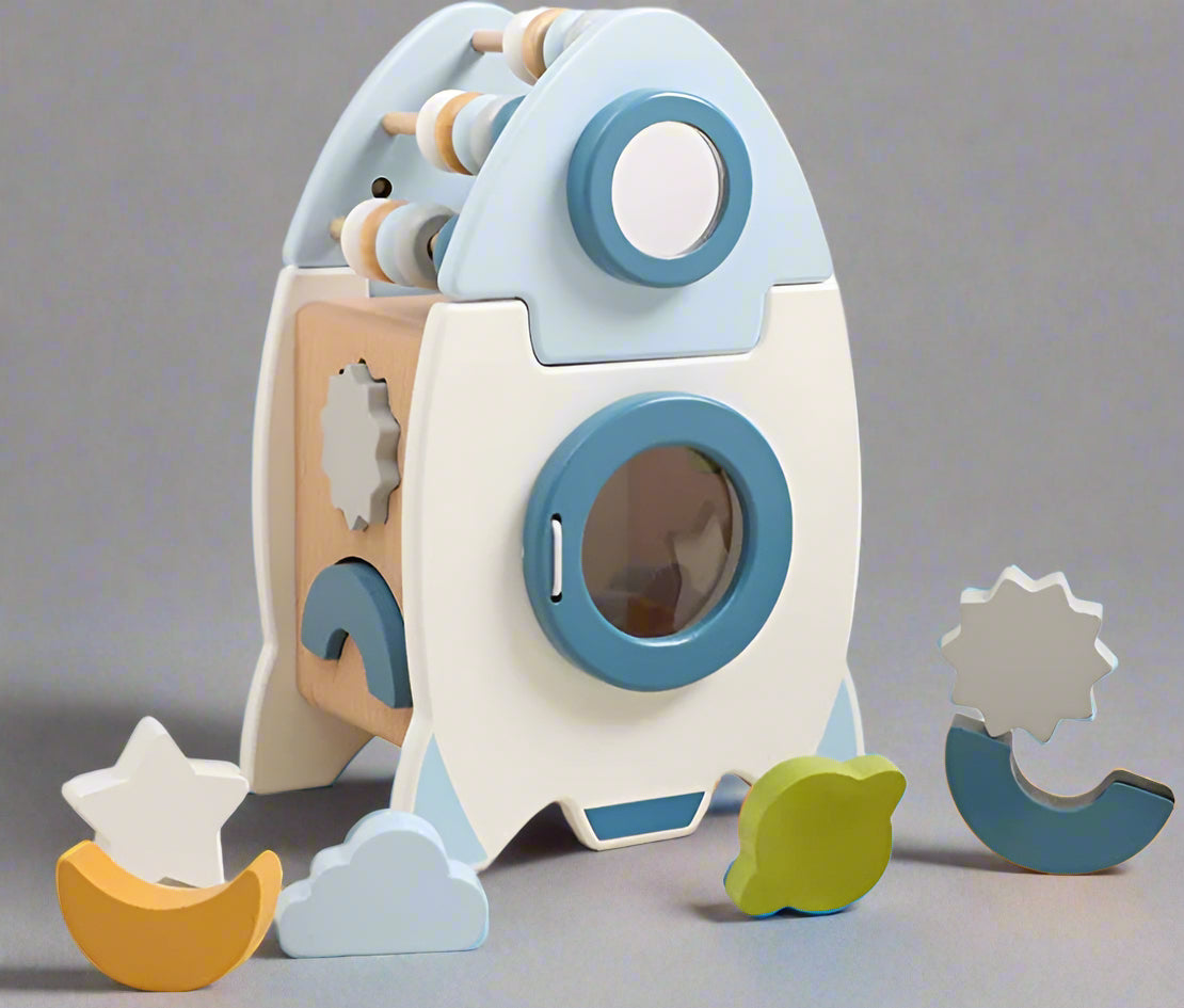 Space-themed wooden toy with rocket and planets
